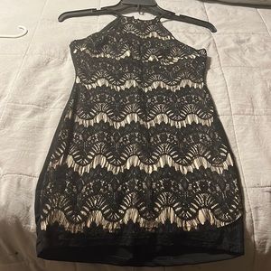 Sarah la dress in black with tan background